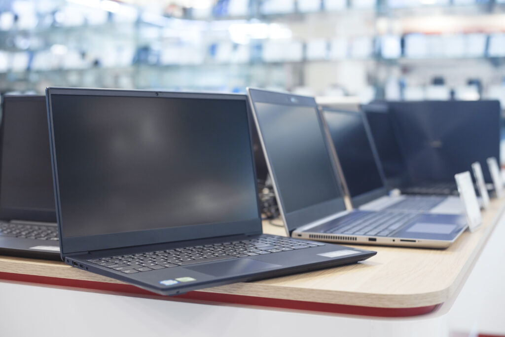 Laptops on the table in the electronics store. Lot pc portable